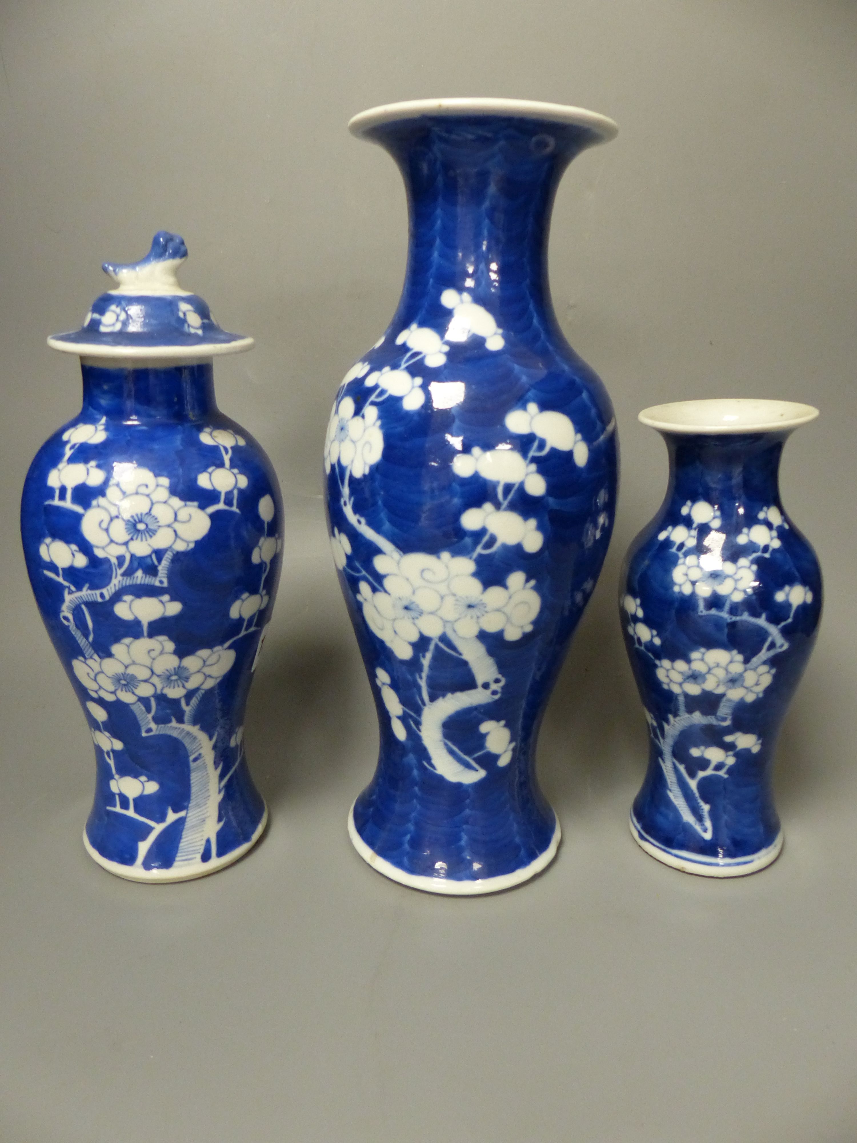 Three similar 19th/20th century Chinese blue and white vases, tallest 30cm